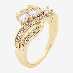 This eye-catching Sparkle Allure 3-stone bypass engagement ring is made with three sparkling cubic zirconia stones and 39 crystals set in a 14K gold-over-brass design. The ring's unique setting showcases the central stones in a graceful, modern twist, adding extra brilliance and elegance. Available in a gift box.Ring Style: Bypass Rings, Engagement Rings, 3-Stone RingsFeatures: In A Gift Box, Nickel FreeStone Cut: RoundStone Millimeter Measurement: 6 Mm Length, 6 Mm WidthMetal Color: Gold ToneBa Bypass Rings, Bypass Engagement Ring, Brass Band, Bypass Ring, Crystal Set, Unique Rings, Cubic Zirconia, Engagement Ring, Gift Box