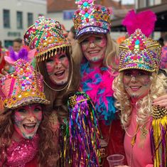 three women dressed in colorful costumes posing for the camera