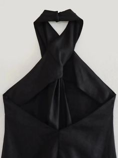 the back of a black top with a tie on it