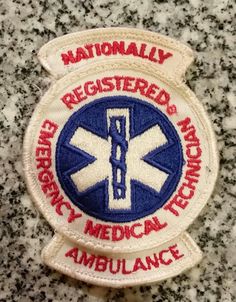 an embroidered patch with the words, emergency medical technician and ambulance on it's side