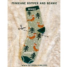 a sock with foxes and pine trees on it that says, minkae romper and beanie