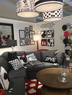 a living room filled with lots of furniture and pictures on the wall above it's coffee table