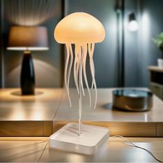 a lamp that is on top of a table with a jellyfish in the middle