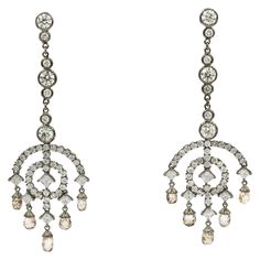 Diamond drop Art Deco motif earrings featuring 80 round brilliants 4.84 carats, 10 princess cut diamonds, 2.17 carats and 10 briolette diamonds, 5.92 carats, in 14k black rhodium. Color: G-H Clarity: SI Art Deco Drop Earrings, White Gold Drop Earrings, White Gold Diamond Earrings, Motif Art Deco, Turquoise Drop Earrings, Art Deco Stil, Estilo Art Deco, Gold Diamond Earrings, Diamond Drop Earrings