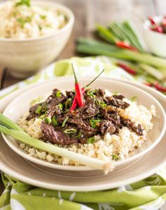 a white plate topped with rice and beef