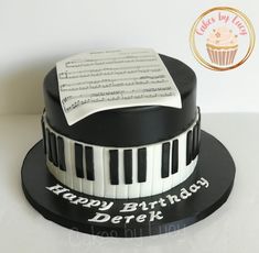 a black and white birthday cake with sheet music