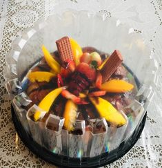 there is a cake with fruit and chocolates in it