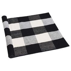 a black and white checkered rug on a white background