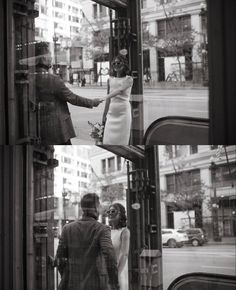 a man and woman are walking down the street in front of a storefront window