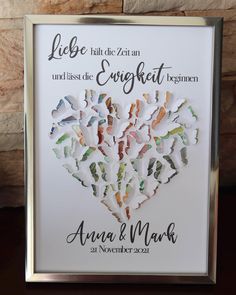 a wedding guest book with paper cut out of the shape of a heart