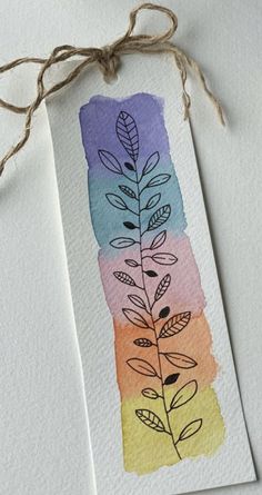 a watercolor bookmark with leaves painted on it