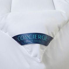 a close up of a white bed with the word concier on it