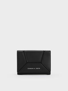 This product is made with at least 20% sustainable materials by weight. CHARLES & KEITH uses recycled, degradable, organic, and water-based materials in our eco-conscious collection. When it comes to this Nasrin wallet, it is all about the subtle details. Upon a closer look, you will notice the unique geometric panels stitched together to create a design that is sleek and eye-catching. Plus, the versatile black finish will never go out of style. This wallet opens up to a well-compartmentalised interior that will keep your cards, cash and coins neat and organised. Bag Photography, Stitched Together, Charles Keith, Sustainable Materials, Your Cards, Card Wallet, Out Of Style, Go Out, A Design