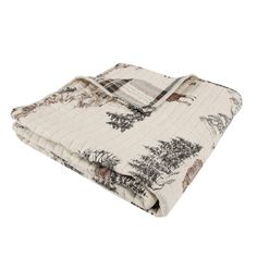 an image of a blanket with animals and trees printed on the front, in white