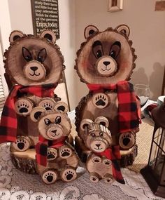 two wooden bears with red and black plaid scarves