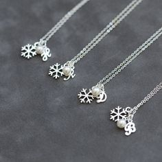 three necklaces with snowflakes hanging from them on a cell phone screenshot