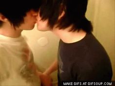 two people kissing each other in front of a mirror