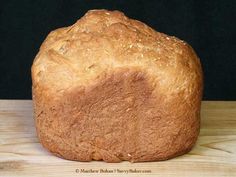 a loaf of bread sitting on top of a wooden table