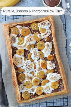 nutella, banana and marshmallow tart on a cooling rack with bananas