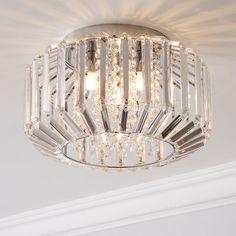 a crystal chandelier hanging from the ceiling in a room with white walls and ceilings