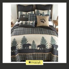 a bed covered in a black and white comforter next to a night stand with an animal print on it