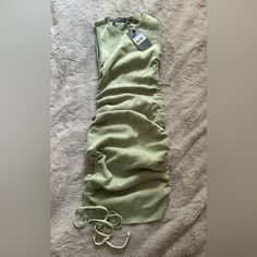 an unmade sleeping bag is laying on a bed with the tag attached to it