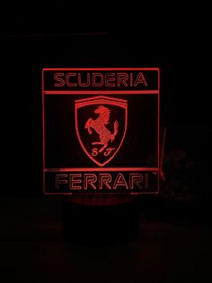 a ferrari illuminated sign in the dark