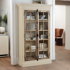 a tall cabinet with glass doors in a living room