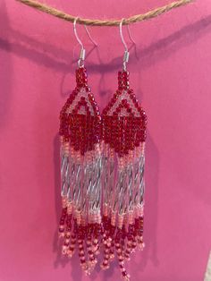 These beaded earrings use magenta, pale pink, silk, and clear beads in a geometric pattern to give off a Barbie summer vibe! They are about 2 inches in length. Summer Faceted Beads Earrings, Pink Chandelier Earrings For Summer Party, Elegant Pink Beaded Earrings For Summer, Pink Large Bead Dangle Earrings, Pink Beaded Earrings With Round Beads For Beach, Pink Dangle Beaded Earrings For Festival, Pink Beaded Fringe Earrings For Party, Pink Dangle Earrings For Summer, Handmade Pink Beaded Earrings For Party