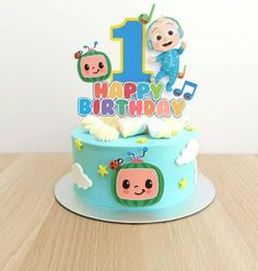 a birthday cake with the number one on it and an image of a cartoon character