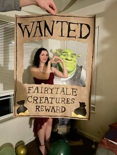 a woman holding up a sign that says, wanted fairytale creatures re - award