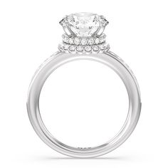 a white gold engagement ring with an oval center stone and two rows of diamonds on the band