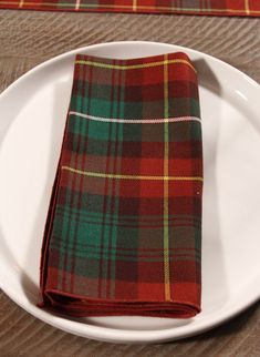 Add a touch of island charm to your home with our Prince Edward Island tartan table runner. Perfect for both formal dining and casual gatherings, the rustic hues of green, rust, yellow, and white make it a stunning centerpiece for any table. Whether you're setting the table for a special dinner or adding a cozy, coastal vibe to your cottage décor, this table runner brings elegance and warmth to any setting. Ideal for everyday use or as a beautiful accent for holidays and special occasions, it’s Air Force Families, Red Sand Beach, Welcome Basket, Canadian Maple Leaf, Red Sand, Stewart Tartan, Hues Of Green, Setting The Table, Special Dinner