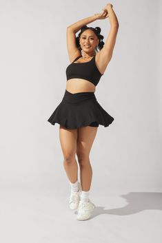 Our most curve-accentuating skort designed for endless twirls and booty shakin’. Meet your newest wardrobe staple. Compression Level: Performance Level: Versatile Workout Skort, Flirty Stretch Skort In Solid Color, Fitted Skort With Wide Waistband For Workout, Fitted Workout Skort With Wide Waistband, Fitted Flirty Black Bottoms, Fitted Black Skort With Wide Waistband, Chic Stretch Skort With Wide Waistband, Black Fitted Skort With Wide Waistband, Black 4-way Stretch Skort For Workout