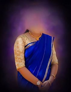 a woman wearing a blue and gold sari with her hands on her hips, in front of a dark background