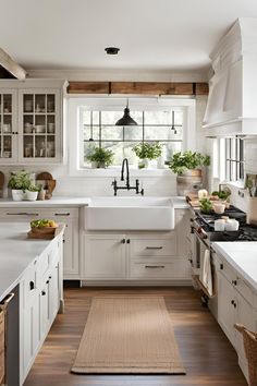 a kitchen with white cabinets and wooden floors is seen in this image from the inside