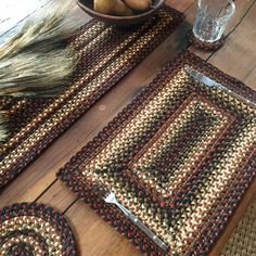 a wooden table topped with two place mats