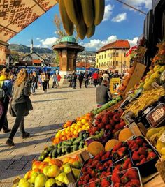 an outdoor market with lots of fruits and vegetables