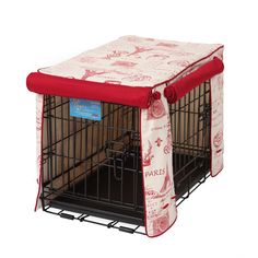 a dog cage with a red and white cover