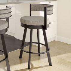 two gray stools sitting in front of a counter