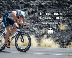 a man riding a bike down a road with a quote on the front and back