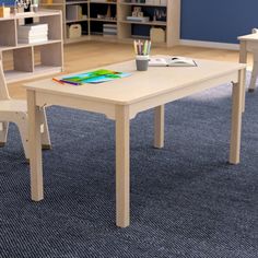 a child's table and chairs in a playroom