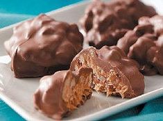 chocolate covered cookies are on a white plate