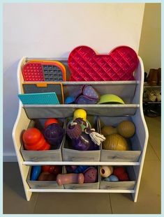 a toy storage unit filled with lots of toys