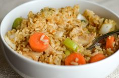 a white bowl filled with rice and carrots