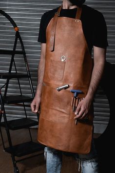 a man wearing an apron and holding a knife