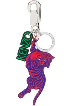 a keychain with a cat on it and the word keno written in green