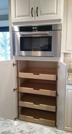 a kitchen with white cabinets and an oven