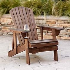 a wooden chair sitting on top of a stone patio