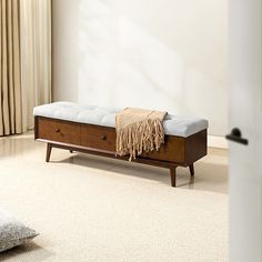 a wooden bench sitting on top of a white carpeted floor next to a window